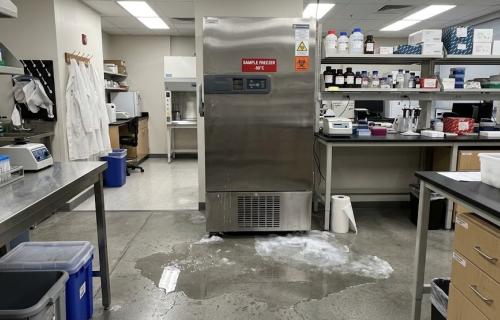 Freezer in the lab with water puddling in front of it